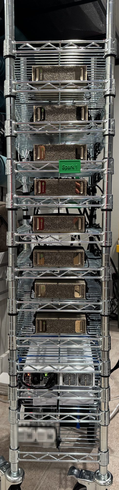 GhettoRak from the front left: the stack of gold DGX Sparks on chrome wire shelves with the green Spark 1 label, open decks below, and the switch and power decks near the casters.
