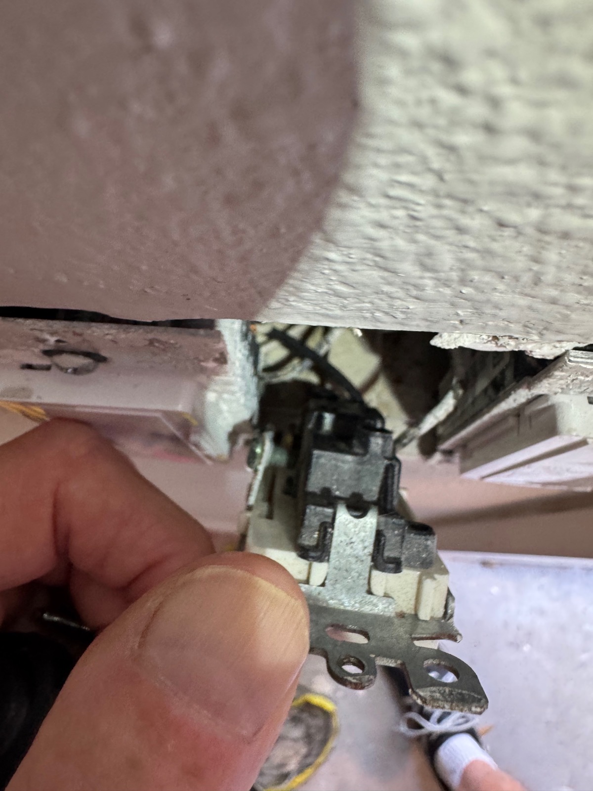 Close-up of old single-pole mechanical switch body and yoke