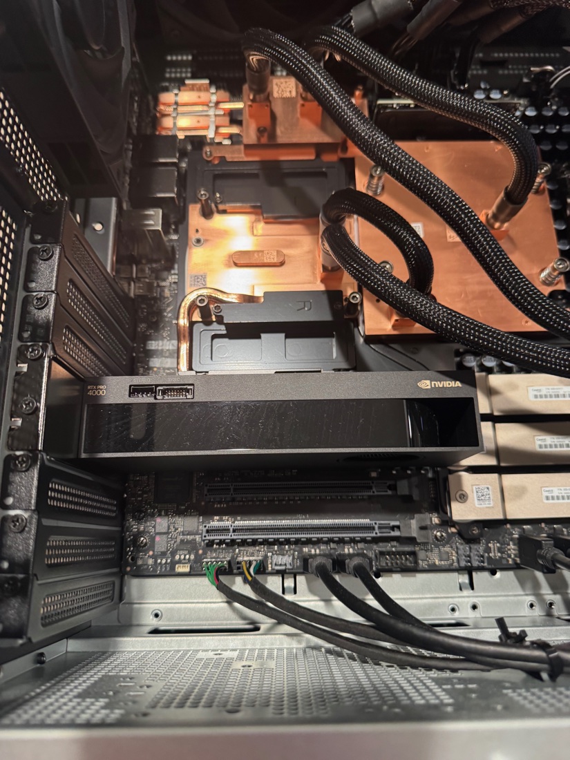 Second angle on the RTX PRO 4000 SFF, showing its single-slot cooler and the liquid-cooling loop behind it